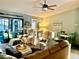 Coastal-themed living room with comfortable seating, nautical decor, and plenty of natural light at 1020 Bowsprit Ln # X, Holiday, FL 34691