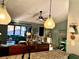 Inviting living room featuring comfortable seating, a ceiling fan, and charming coastal decor accents at 1020 Bowsprit Ln # X, Holiday, FL 34691