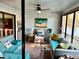 Cozy sun room with comfortable seating, a ceiling fan, and views of the lake at 1020 Bowsprit Ln # X, Holiday, FL 34691