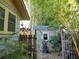 Enclosed backyard with a storage shed is enhanced by a garden gate and mature bamboo at 1044 Virginia Dr, Sarasota, FL 34234