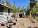 View of the home's backyard featuring a variety of greenery and a metal fence at 1044 Virginia Dr, Sarasota, FL 34234