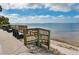 Inviting beach access with wooden stairs leading to the sandy beach and ocean view at 1044 Virginia Dr, Sarasota, FL 34234