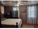 Cozy bedroom with wood-paneled walls, hardwood floors, and a comfortable bed at 1044 Virginia Dr, Sarasota, FL 34234