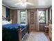 Cozy bedroom with natural light, wood walls, and unique decor at 1044 Virginia Dr, Sarasota, FL 34234