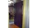 Open doorway with unique door and a view of interior with wood-paneled walls and hardwood floors at 1044 Virginia Dr, Sarasota, FL 34234