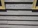 Exterior detail showcasing the weathered gray wood siding with yellow trim at 1044 Virginia Dr, Sarasota, FL 34234