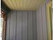 Exterior close up with textured wood paneling and a glimpse of the surrounding outdoor space at 1044 Virginia Dr, Sarasota, FL 34234