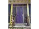 Inviting front door with unique tiki statues, and a decorative sunburst trim above the door at 1044 Virginia Dr, Sarasota, FL 34234