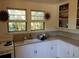 Bright kitchen with vintage charm, featuring a classic sink and well-organized open shelving at 1044 Virginia Dr, Sarasota, FL 34234