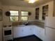Charming kitchen with white cabinets, a gas range, and natural light filtering through the windows at 1044 Virginia Dr, Sarasota, FL 34234