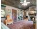 Living room featuring wood-paneled walls, a stone fireplace, and unique decor at 1044 Virginia Dr, Sarasota, FL 34234