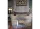 Living room showcasing a stone fireplace with brick interior and wood flooring at 1044 Virginia Dr, Sarasota, FL 34234
