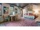 Inviting living room with wood walls, purple carpet, and eclectic decor at 1044 Virginia Dr, Sarasota, FL 34234