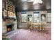Cozy living room with stone fireplace, wood-paneled walls, and vintage decor at 1044 Virginia Dr, Sarasota, FL 34234