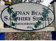 Sign for Indian Beach Sapphire Shores Neighborhood with palm tree accents and established in 1891 at 1044 Virginia Dr, Sarasota, FL 34234