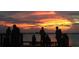 Picturesque waterfront sunset with silhouettes of people enjoying the serene atmosphere on the pier at 1044 Virginia Dr, Sarasota, FL 34234