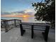 Scenic waterfront view with a bench overlooking the calm water at sunset; peaceful outdoor space at 1044 Virginia Dr, Sarasota, FL 34234