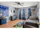 Bedroom featuring wood flooring, a ceiling fan, and natural light at 11041 Claymore St, Spring Hill, FL 34608