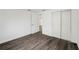 Bedroom with sleek wood-look floors, closet, and white painted walls at 1109 Landau St, Holiday, FL 34690