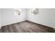 Bright bedroom with two windows and sleek, modern wood-look flooring at 1109 Landau St, Holiday, FL 34690
