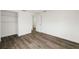 Bedroom featuring wood-look floors, closet, and doorway at 1109 Landau St, Holiday, FL 34690