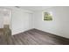 Cozy bedroom featuring wood-look floors, closet, and a bright window at 1109 Landau St, Holiday, FL 34690