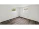Bright bedroom featuring two windows and modern wood-look flooring at 1109 Landau St, Holiday, FL 34690