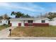 Charming single-story home with a well-maintained front yard and red brick accents at 1109 Landau St, Holiday, FL 34690