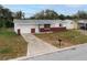 Charming single-story home featuring a well-maintained front yard, attached garage, and concrete driveway at 1109 Landau St, Holiday, FL 34690