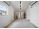 Spacious garage with concrete floors, two doors, and overhead lighting at 1109 Landau St, Holiday, FL 34690