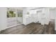 Bright kitchen with white cabinets, stainless steel appliances, and outdoor access at 1109 Landau St, Holiday, FL 34690