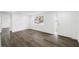Bright living room with wood-look floors and a glass-paneled front door at 1109 Landau St, Holiday, FL 34690