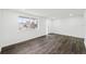 Light-filled living room with wood-look floors, and a large picture window at 1109 Landau St, Holiday, FL 34690