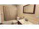 Standard bathroom featuring a shower-tub combo and neutral tiling at 11722 Currie Ln # E1, Largo, FL 33774