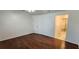 Well-lit bedroom showcasing hardwood floors, a convenient bathroom access, and a closet at 11722 Currie Ln # E1, Largo, FL 33774