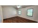 Bedroom with hardwood flooring and natural light from dual windows at 11722 Currie Ln # E1, Largo, FL 33774