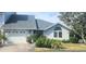 Charming home featuring an attached garage, well maintained landscaping, and a welcoming entrance at 11722 Currie Ln # E1, Largo, FL 33774