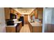 Well-lit kitchen features wooden cabinets, modern appliances, and light countertops at 11722 Currie Ln # E1, Largo, FL 33774