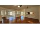 Spacious living room with hardwood floors and multiple access points to other rooms at 11722 Currie Ln # E1, Largo, FL 33774