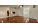 Open-concept living room featuring hardwood floors, and a partial view of the entryway and kitchen at 11722 Currie Ln # E1, Largo, FL 33774