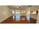 Open-concept living room featuring hardwood floors and large windows offering ample natural light at 11722 Currie Ln # E1, Largo, FL 33774