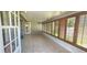 Enclosed sunroom with tiled floors and wood shutter windows at 11722 Currie Ln # E1, Largo, FL 33774