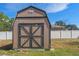 Exterior view of a backyard shed, with a traditional design and double doors at 12428 Maleo Rd, Weeki Wachee, FL 34614