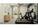 Inviting exercise room showcasing a stationary bike and treadmill, illuminated by natural light from a nearby window at 13035 Ruby Gold Ct, Wimauma, FL 33598