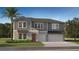 Charming two-story home with a gray exterior, complemented by a well-maintained lawn and a two-car garage at 13035 Ruby Gold Ct, Wimauma, FL 33598
