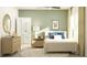 Serene main bedroom featuring a comfortable bed, dresser, and en-suite bathroom with modern fixtures at 13035 Ruby Gold Ct, Wimauma, FL 33598