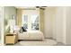 Bright main bedroom with a comfortable bed, neutral decor, and a large window that offers ample natural light at 13035 Ruby Gold Ct, Wimauma, FL 33598