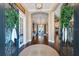 Inviting foyer with wood floors, decorative rug, open layout, arched doorways, and stylish light fixtures at 15918 Sorawater Dr, Lithia, FL 33547