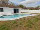 Inviting backyard with refreshing private pool, and surrounded by a clean white fence at 16147 Sagebrush Rd, Tampa, FL 33618