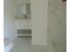 Bathroom featuring white marble floors and walls, and a vanity with gold fixtures at 16147 Sagebrush Rd, Tampa, FL 33618